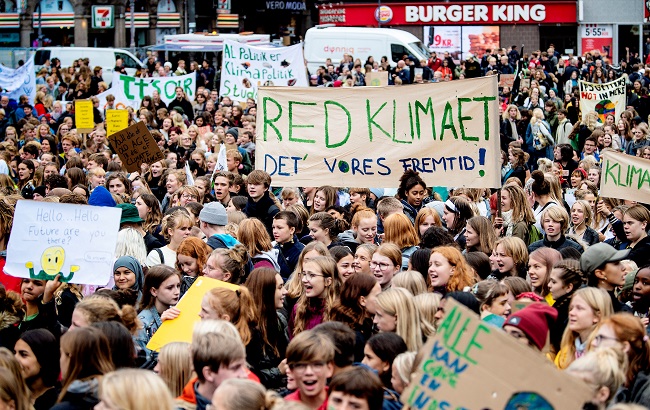 People hold placards during the Global Climate Strike at Raadhuspladsen in Copenhagen, Denmark September 20, 2019.