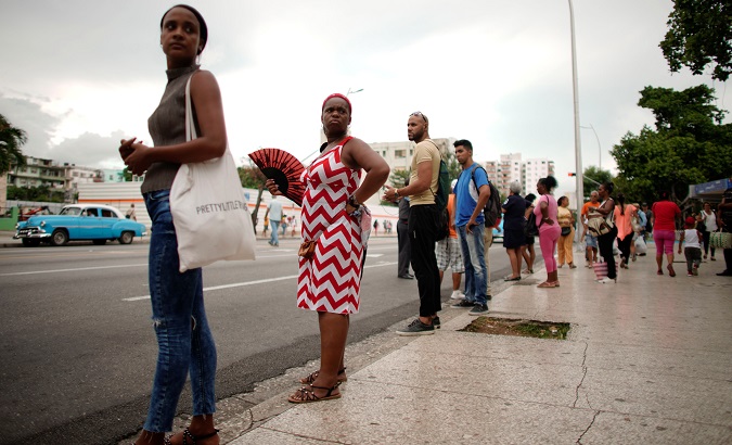 People wait for public transportation in Havana, Cuba, Sep. 13, 2019.