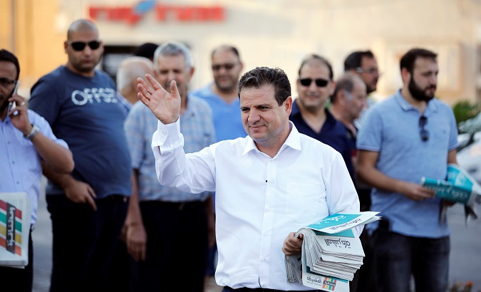 Ayman Odeh, leader of the Joint List, gestures as he hands out pamphlets during an an election campaign event in Tira, northern Israel Sept. 5, 2019.