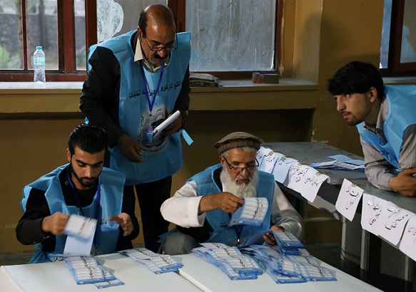 Afghan election commission workers count ballot papers of the presidential election in Kabul, Afghanistan September 28, 2019.