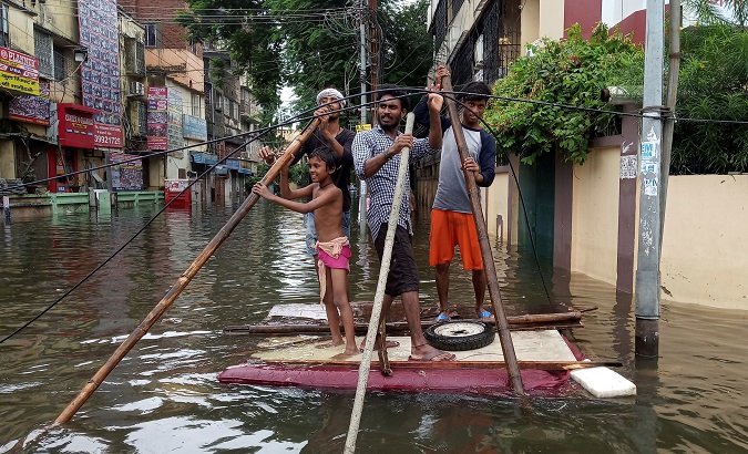 People use a makeshift raft to move out of a flooded neighbourhood in Patna, in the eastern state of Bihar, India, September 30, 2019.