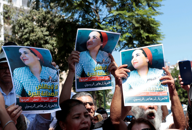 Moroccan activists hold posters of Hajar Raissouni, a journalist charged with having sex before marriage and having an illegalabortion, during a protest outside the Rabat tribunal, Morocco, September 9, 2019.