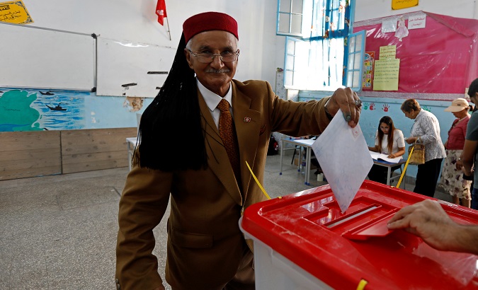 A man casts his ballot at a polling station during parliamentary elections, in Tunis, Tunisia Oct. 6, 2019.