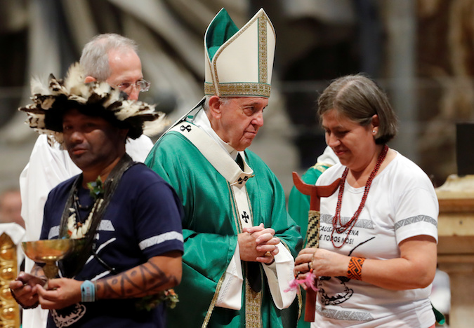 Pope Francis greets indigenous leaders from the Amazonas region as he leads a Mass to open a three-week synod of Amazonian bishops at the Vatican, October 6, 2019.