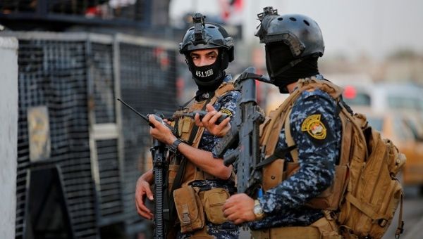 Members of Iraqi federal police are seen with military vehicles in a street in Baghdad, Iraq October 7, 2019.