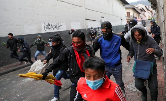 Demonstrators run away from the riot police during a protest against Ecuador's President Lenin Moreno's austerity measures in Quito, Ecuador, October 8, 2019.