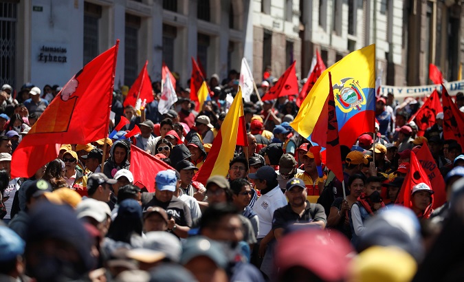 Demonstrators hold flags during a protest against Ecuador's President Lenin Moreno's austerity measures in Quito, Ecuador, October 9, 2019.