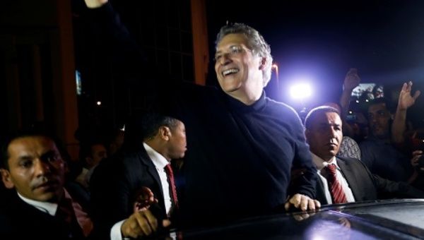 Tunisian presidential candidate Nabil Karoui greets his supporters after he was freed in Tunis.