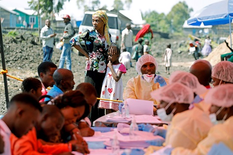 A woman and child wait to receive the Ebola vaccination in Goma, DRC.
