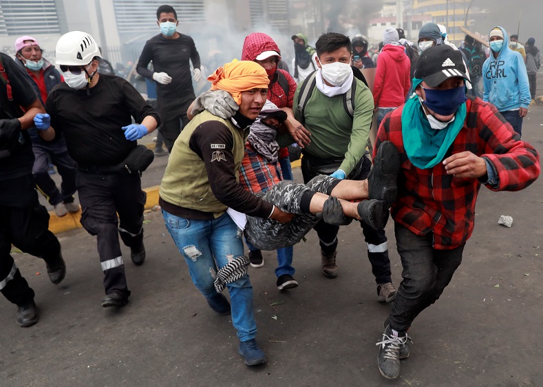 Injured demonstrator is carried by others in Quito, Ecuador October 12, 2019. 