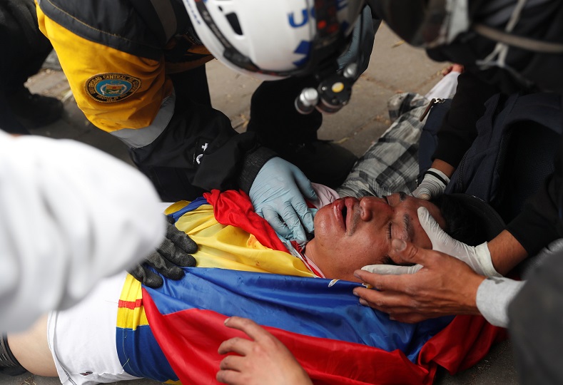Injured citizen is helped by paramedics in Quito, Ecuador, October 12, 2019. There are no official aggregate figures on the number of people injured.