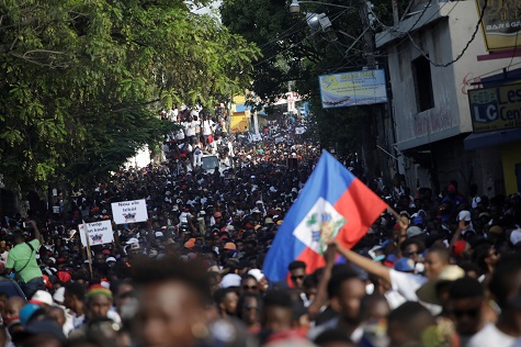 Protesters march during a demonstration called by artists to demand the resignation of Jovenel Moise, in the streets of Port-au-Prince.
