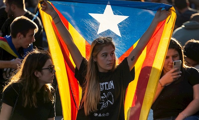 Woman holds a Catalan flag in protests in favor of the freedom of nine pro-independence leaders in Barcelona, Catalonia, Spain, Oct. 15, 2019.