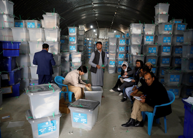 An Afghan election commission worker opens ballot boxes and election materials at a warehouse in Kabul, Afghanistan October 7, 2019. Picture taken October 7, 2019.