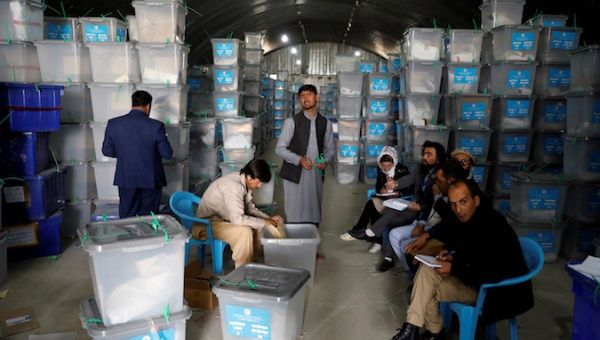 An Afghan election commission worker opens ballot boxes and election materials at a warehouse in Kabul, Afghanistan October 7, 2019. Picture taken October 7, 2019. 