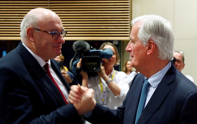 European Trade Commissioner-designate Phil Hogan greets European Union's chief Brexit negotiator Michel Barnier as he leaves after attending a news conference at European Council building in Brussels, Belgium, October 17, 2019