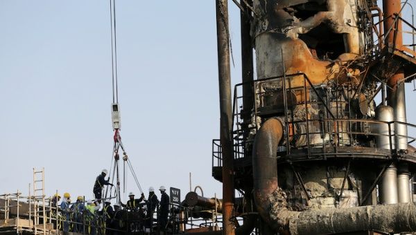 Workers are seen at the damaged site of Saudi Aramco oil facility in Abqaiq, Saudi Arabia, September 20, 2019.
