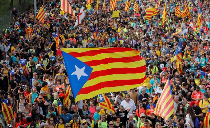 People wave pro-independence during Catalonia's general strike in Sant Just Desvern, Spain, Oct. 18, 2019.