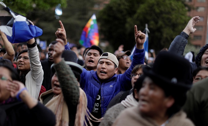 People shout slogans as supporters of MAS party of President Evo Morales and supporters of opposition candidate Carlos Mesa of Citizen Community party gather in front of the official electoral computing center in La Paz, Bolivia, October 21, 2019.