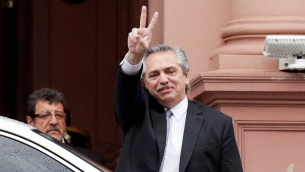 President-elect Alberto Fernandez flashes a V sign as he leaves after a meeting with Argentina's President Mauricio Macri at the presidential palace Casa Rosada.