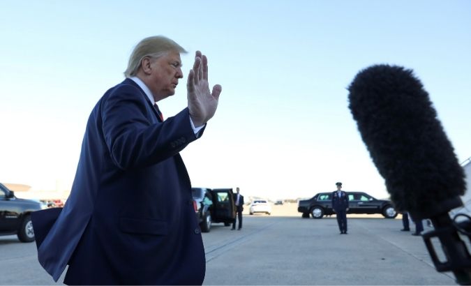 U.S. President Donald Trump waves to reporters prior to departing Washington for travel to Chicago at Joint Base Andrews, Maryland, U.S., October 28, 2019.