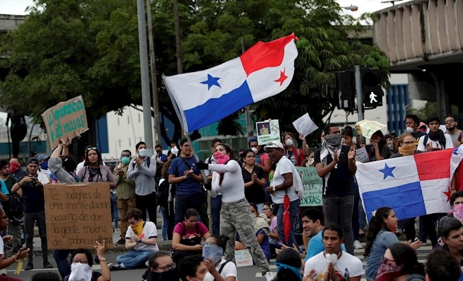 A protester flies a Panama flag during a student protest in front of the National Assembly in Panama City, Panama, Oct. 31, 2019.