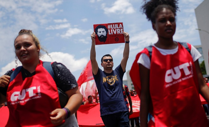 Citizen holds a sign that reads 'Free Lula' during a protest against President Jair Bolsonaro in Brasilia, Brazil Oct. 30, 2019.