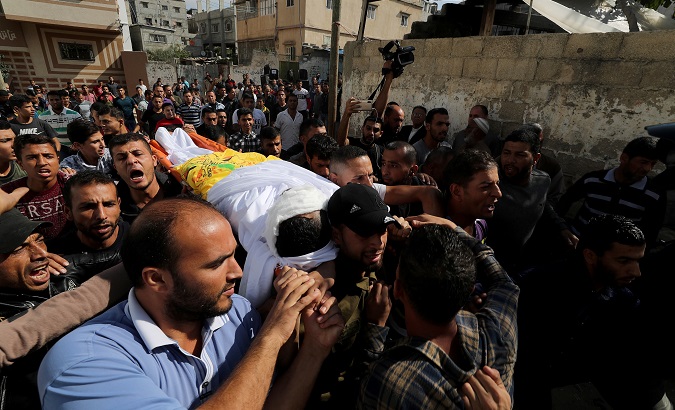 Mourners carry the body of Palestinian Ahmed Al-Shahri, 27, during his funeral Khan Younis in the southern Gaza Strip Nov. 2, 2019.