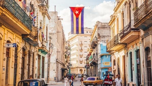 The Cuban flag waves over a street in downtown Havana, Cuba, Oct. 2019.