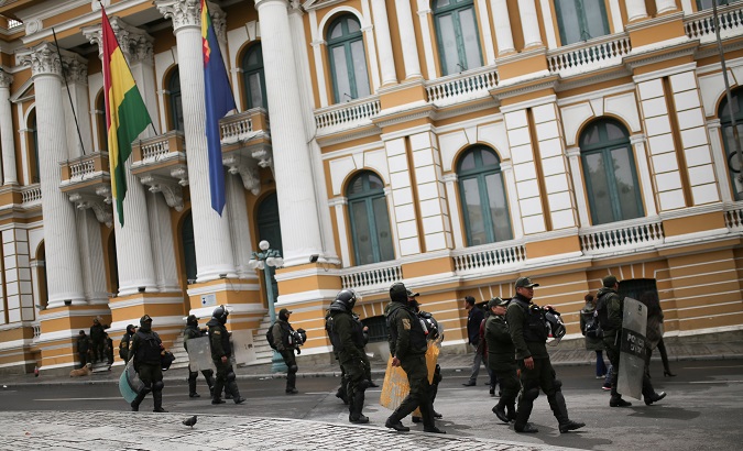 Members of the security forces patrol a street, at the Murillo square, in La Paz.