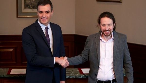 Spanish acting Prime Minister Pedro Sanchez and Unidas Podemos (Together We Can) leader Pablo Iglesias shake hands during a news conference at Spain's Parliament in Madrid, Spain, November 12, 2019. 