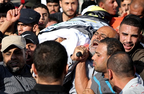 Mourners carry the body of Palestinian Islamic Jihad field commander Baha Abu Al-Atta during his funeral in Gaza City.