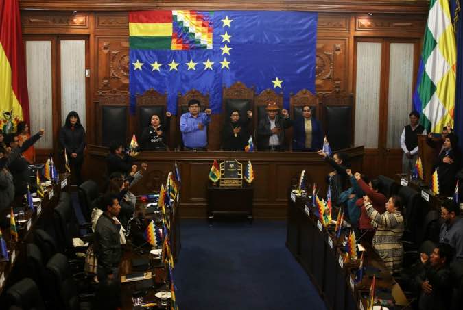 Senator Monica Eva Copa Murga, of the Movement Toward Socialism (MAS) party, waves flags after being sworn in as president of the Bolivian Senate in La Paz, Bolivia