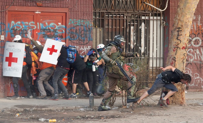 Military police officer attacks citizen during a protest against Sebastian Piñera's government in Santiago, Chile, Nov. 14, 2019.