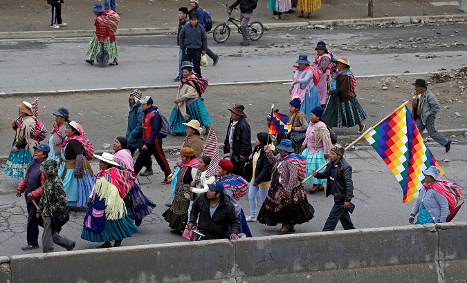 Supporters of Bolivia's President Evo Morales carry Wiphala flags as they block roads in El Alto, Bolivia, Nov. 15, 2019