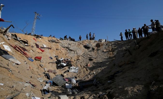 Palestinians gather at the scene of an Israeli air strike in the central Gaza Strip November 14, 2019.