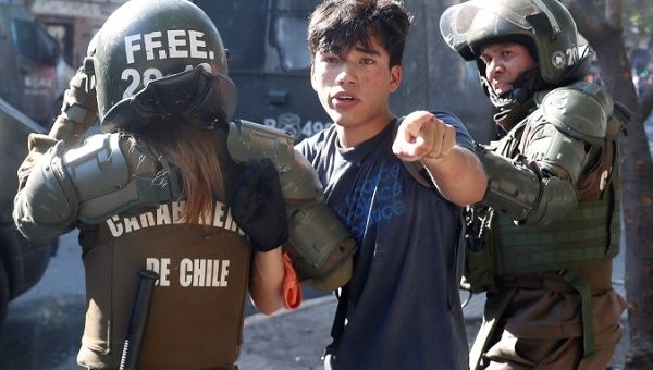 Student is detained by police during a protest against Sebastian Piñera's administration in Santiago, Chile Nov. 20, 2019.