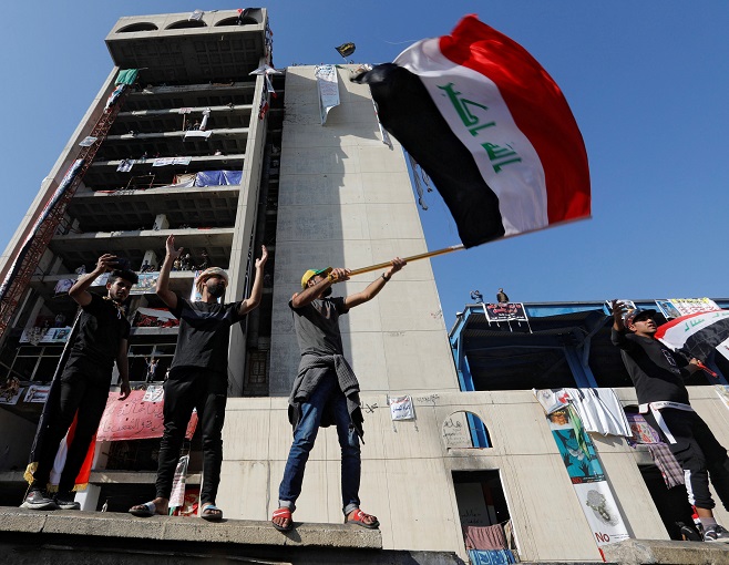 Demonstrators gesture as they take part in ongoing anti-government protests in Baghdad, Iraq November 21, 2019.