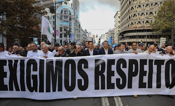 Police officers hold a banner that reads 'We Demand Respect' in Lisbon, Portugal, Nov. 21, 2019.