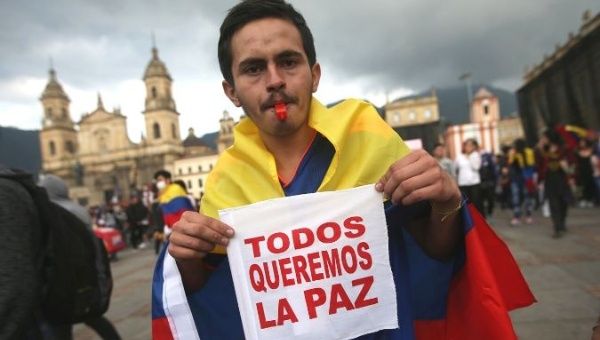 A protester holds a placard during a demonstration on Plaza de Bolivar as the national strike continues, in Bogota, Colombia November 24, 2019. The placard reads: 