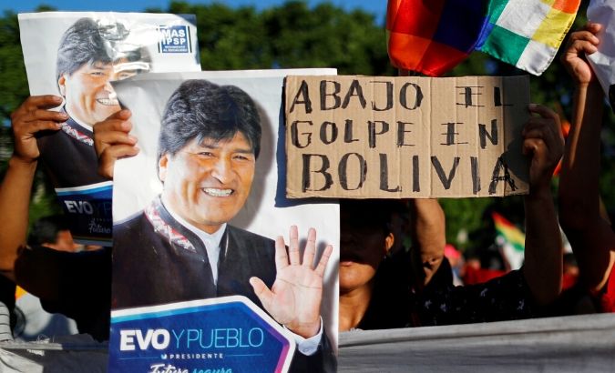 Supporters of Bolivia's ousted President Evo Morales hold a placard that reads 
