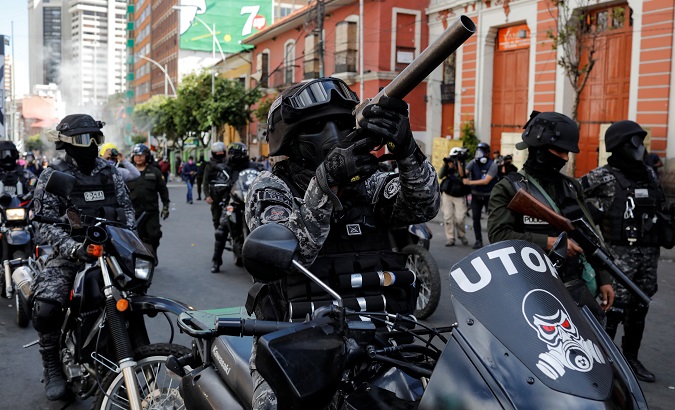 A member of the riot police aims his weapon during a protest in La Paz, Bolivia Nov. 21, 2019.