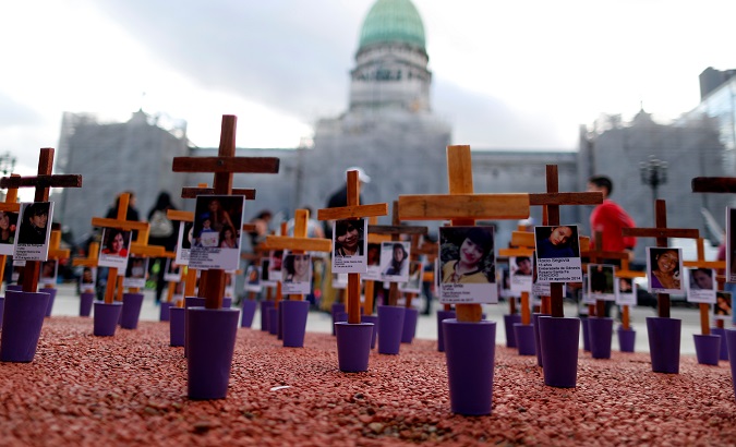 Crosses with pictures of victims of violence are seen in front of the National Congress in Buenos Aires, Argentina Nov. 25, 2019.