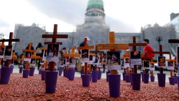 Crosses with pictures of victims of violence are seen in front of the National Congress in Buenos Aires, Argentina Nov. 25, 2019.