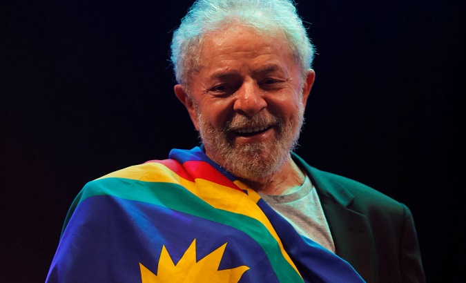 Lula da Silva is draped in the flag of the Pernambuco State in Recife, Brazil, Nov. 17, 2019.