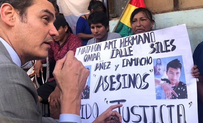 Inter-American Commission on Human Rights Secretary Paulo Abrao meets relatives of the victims of repression in Bolivia. The sign reads “They killed my brother Omar Calle. Siles, Añez, and Camacho are murderers. I demand justice”. Nov. 25, 2019.