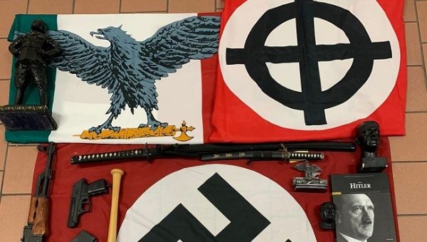Italian police handout shows weapons and a Nazi flag with a swastika that they say were seized in searches of properties of an extreme right group who planned to create a new Nazi party, in an unidentified location in Italy in a picture released on November 28, 2019. 