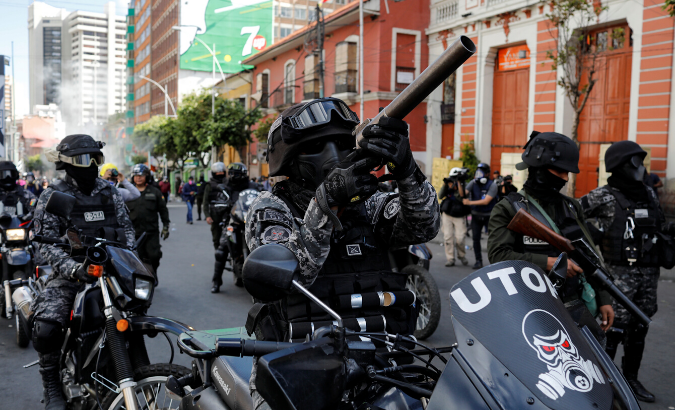 A member of the riot police aims his weapon during a protest, in La Paz, Bolivia November 21, 2019.