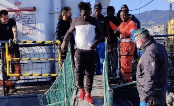 Migrants rescued from the Mediterranean left the vessel Alan Kurdi in Messina, Italy, Dec. 4, 2019..