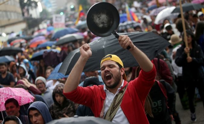A man bangs a pan during a protest march combined with concerts as a national strike continues in Bogota, Colombia December 8, 2019.
